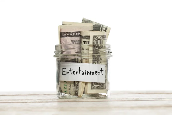 Dollaro USA denaro per l'intrattenimento nel risparmio vaso di vetro su tavolo di legno su sfondo bianco — Foto Stock
