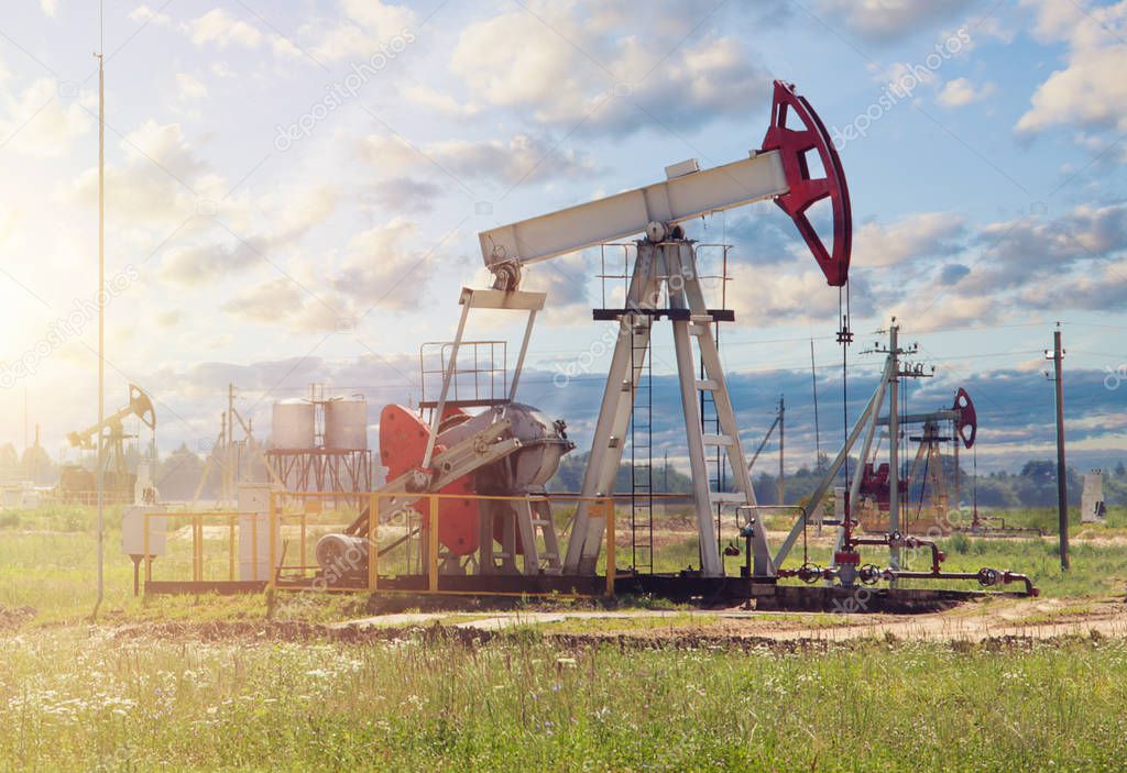 Oil pumpjack on sky clouds background.  Oil well industry