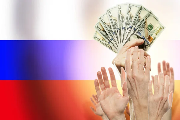 People raising hands with dollars and flag Russia on background.