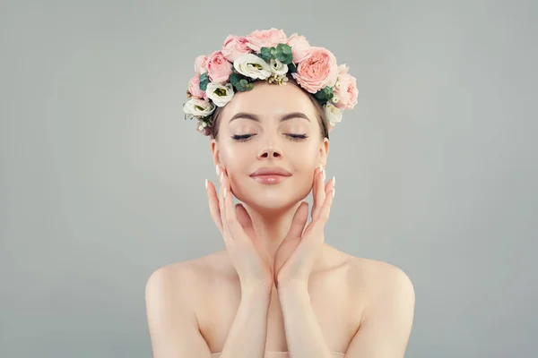 Relaxing woman with clear healthy skin and flowers crown portrait