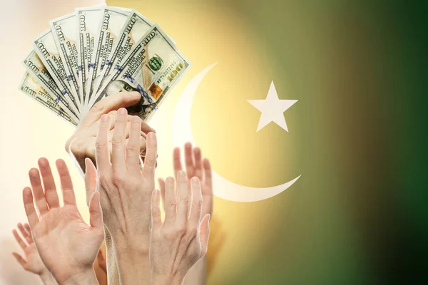 People raising hands with dollars and flag Pakistan on backgroun