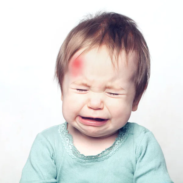 Little baby with bruise crying. Medical concept