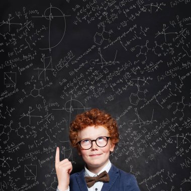 Smart child boy with curly ginger hair in glasses.  clipart