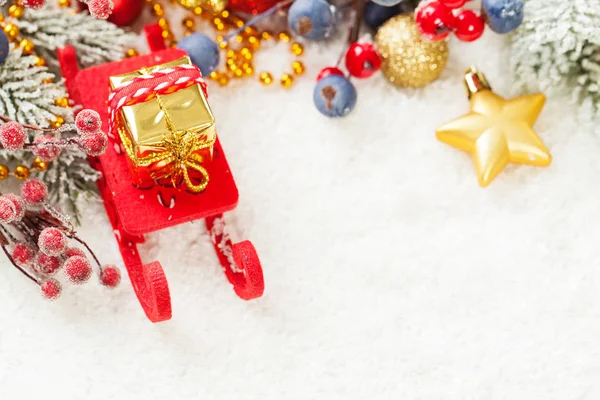 Weihnachtskomposition mit rotem Weihnachtsmann-Schlitten und Weihnachtsgeschenk — Stockfoto