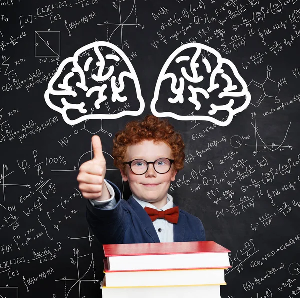 Little student boy 9 year old with books on chalkboard background — 스톡 사진