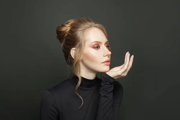 Elegant fashion model on black background, portrait