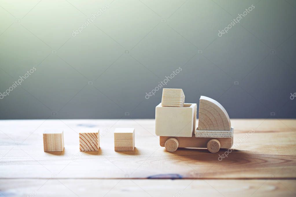 Wooden model of truck loading freight, shipping and delivery concept.