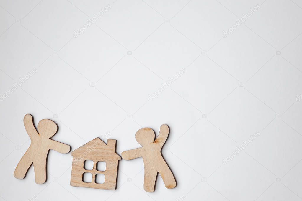 little wooden men and house with blank white space for text or logo. Symbol of construction, family, sweet home concept