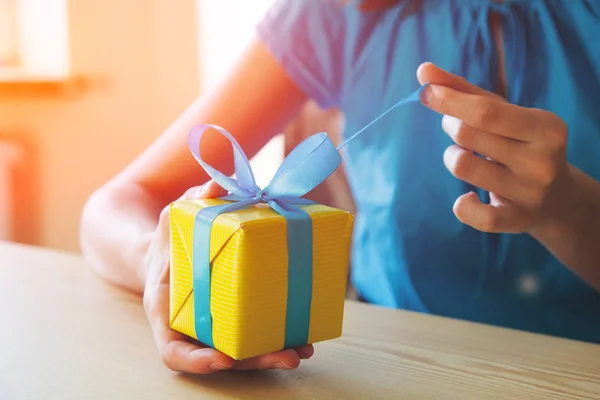 girl opening surprise gift box with ribbon