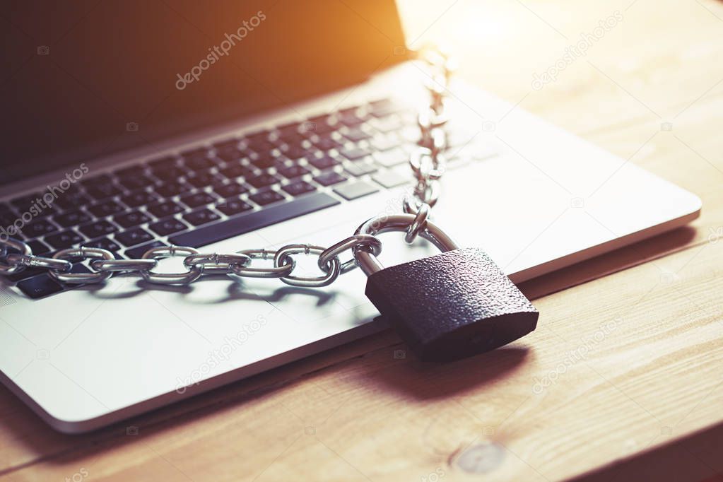 Locked chain on laptop as computer protection and cyber safety concept. Private data protection from hacker malware