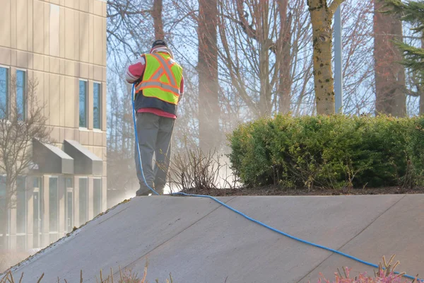 Worker Wears Reflective Safety Vest While Power Washing City Landscaping — Stock Photo, Image