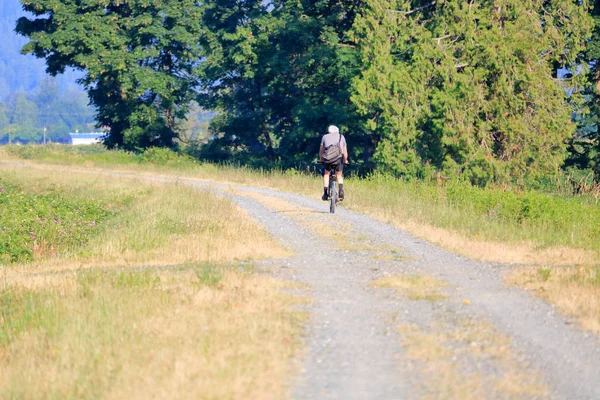 Senior Citizen Enjoys Scenic Ride Winding Rural Road Surrounded Nature — Stock Photo, Image