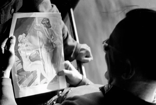 1941年 一名德国士兵正在看一幅描绘部分穿着女人的小画像 — 图库照片