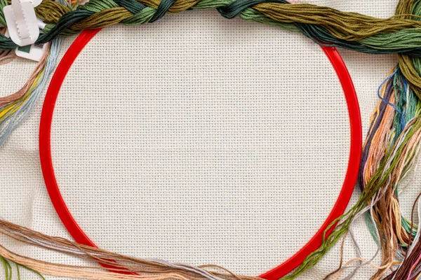 Embroidery frames, embroidery stitching kit with color threads and canvas background with copy space