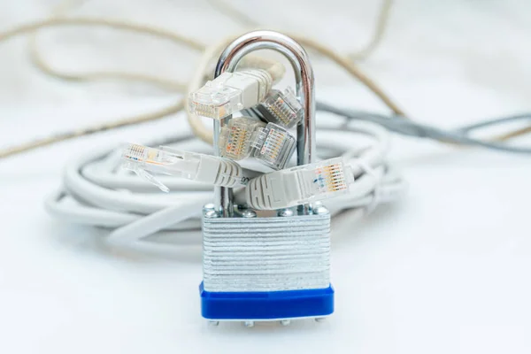 bundle of network wires blocked with metal padlock on white background