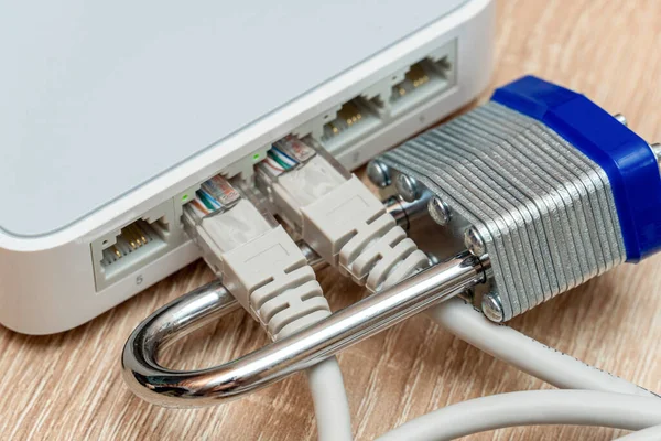 bundle of network Ethernet wires in router locked with metal padlock