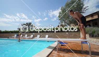 Bir çocuğun çalıştıran ve bir yüzme havuzu bir tahta atlama atış robot