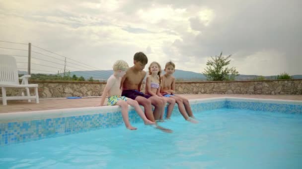 Cuatro Niños Trajes Baño Están Sumergiendo Sus Pies Mientras Sonríen — Vídeo de stock