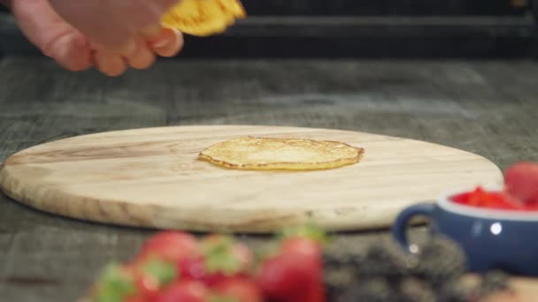 Pancakes placed on wooden cutting board — Stock Video