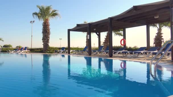Tournage régulier de la piscine bleue par une journée venteuse 