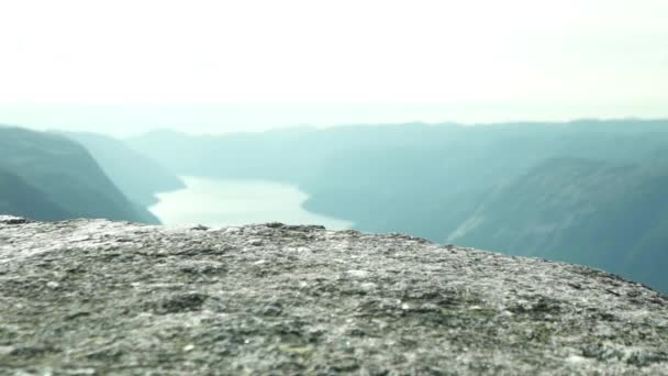 Närbild av Kjeragbolten yta och en panoramautsikt över floder och berg — Stockvideo