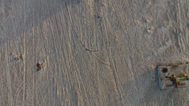 Blick aus der Vogelperspektive auf ein altes Boot aus dem Wasser, das im Sand am Strand geparkt ist — Stockvideo