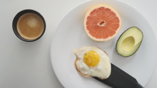Desayuno simple con huevo soleado boca arriba que se agrega en la placa blanca — Vídeos de Stock