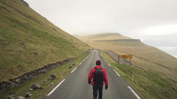 Hiker Walking On Mountain Road On Vidareidi — Stock Video