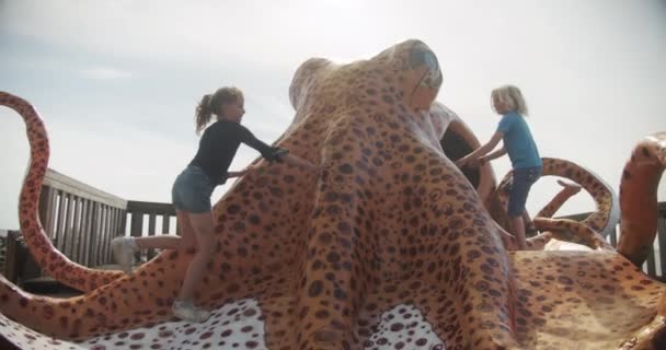 Boy And Girl Playing On Large Model Octopus — Stock Video