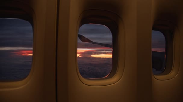 Majestueux ciel orange au coucher du soleil et une aile d'avion par la fenêtre — Video