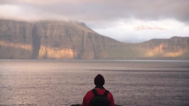 Hiker Looking out Over Sea To Coastline — стоковое видео