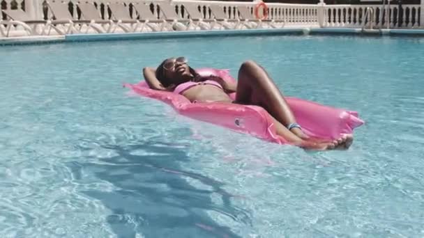 Close-up shot van vrouw op opblaasbaar in zwembad zonnebaden — Stockvideo