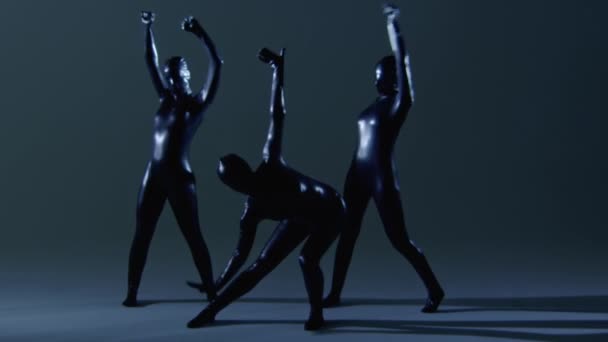 Three Dancers in Slow Motion Dancing in Latex Overalls — Stock Video