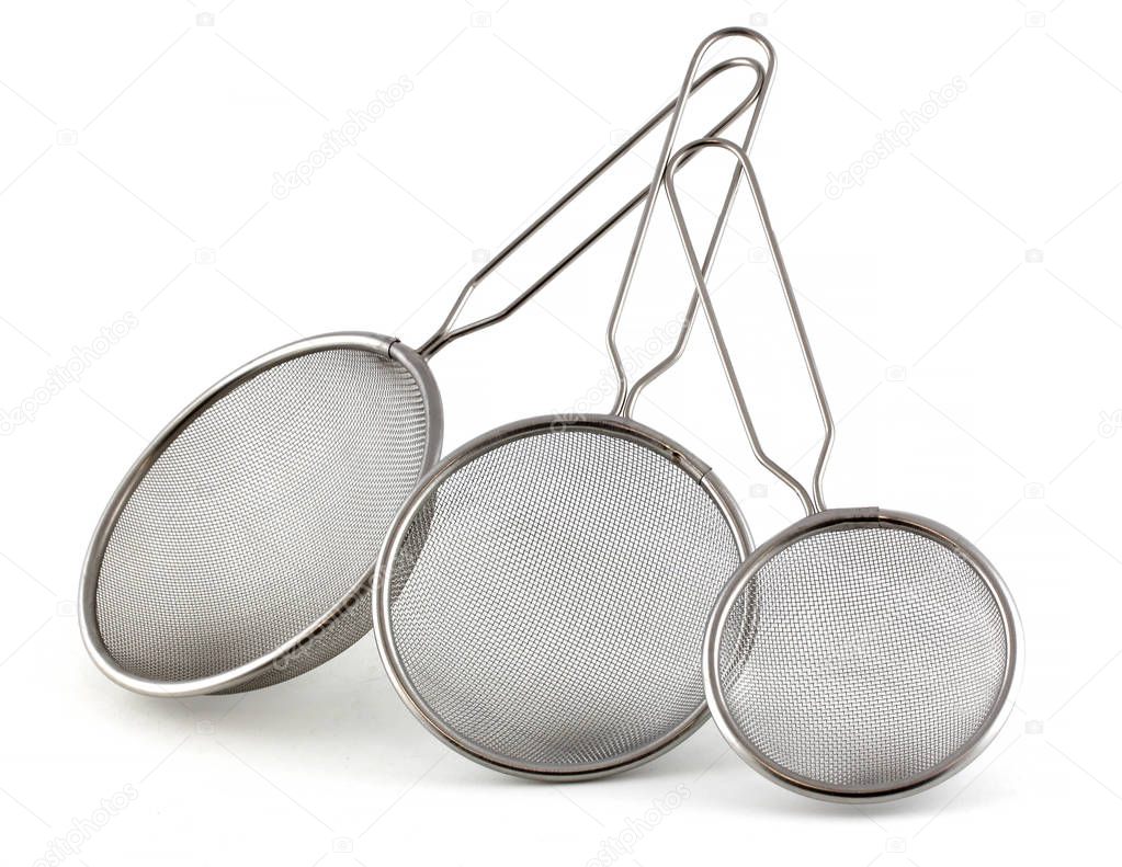 Set of kitchen strainers of different sizes on a white background. The smallest tea strainer and the largest for rice or pasta.