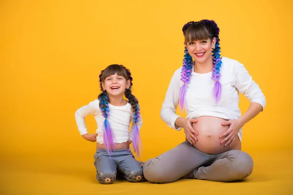 Positive pregnant mother and funny daughter — Stock Photo, Image