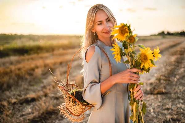 Positive young blonde woman in light summer dress — Stok fotoğraf