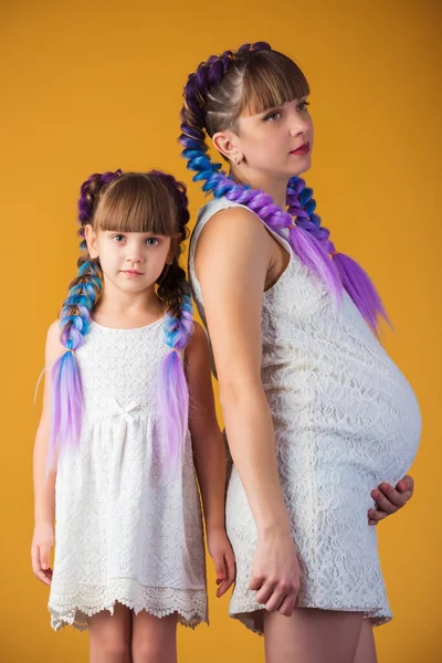 Beautiful little girl and pregnant mother — Stock Photo, Image