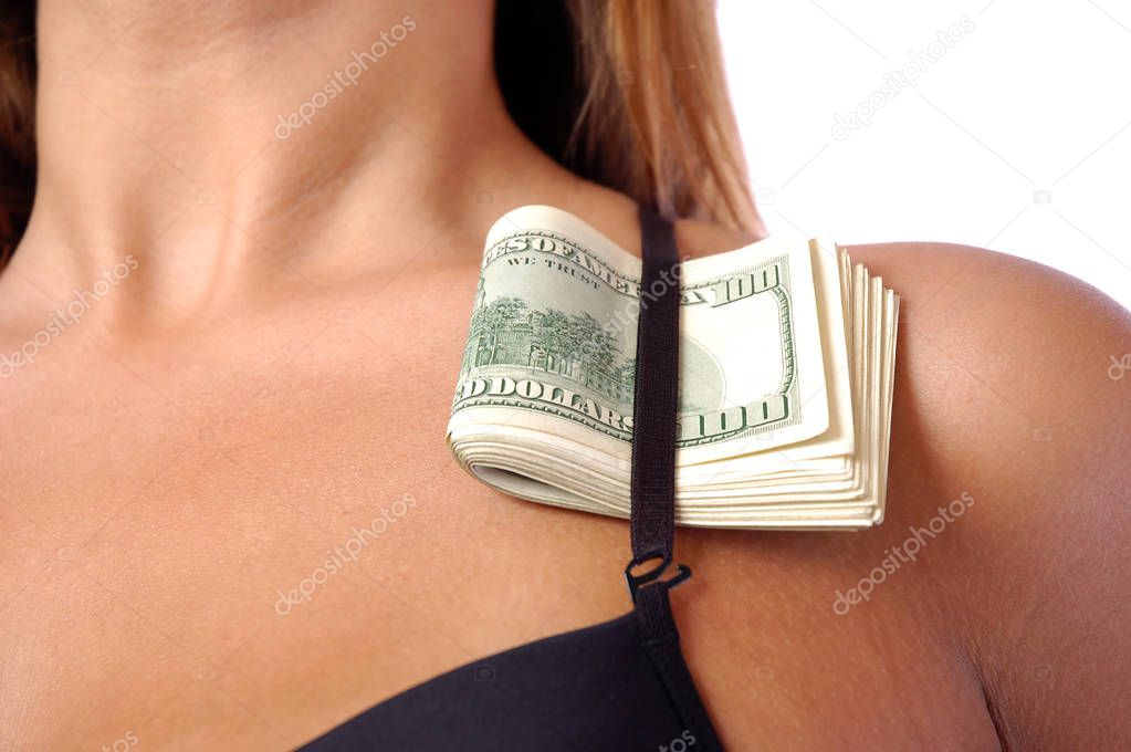 Dollars under the bra strap of a woman