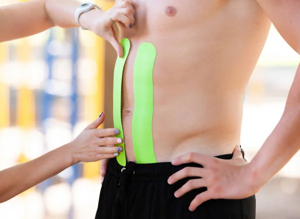 Therapist Sticks Bright Kinesio Tapes Stomach Man — Stock Photo, Image