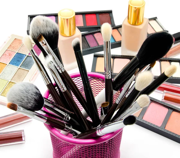 Various set of professional makeup brushes and cosmetics and pal