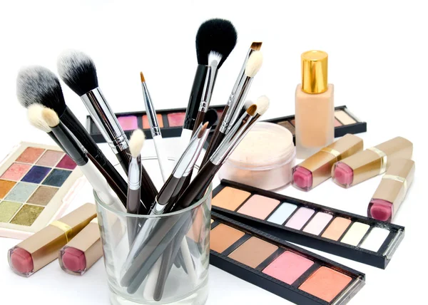 Various set of professional makeup brushes and cosmetics and pal