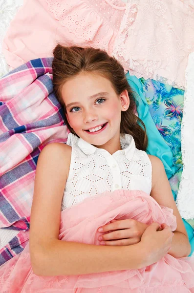 Portrait of smiling happy little girl child schoolgirl lying on — Stock Photo, Image