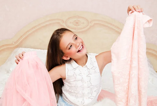 Portrait of smiling happy little girl child schoolgirl choosing — Stock Photo, Image