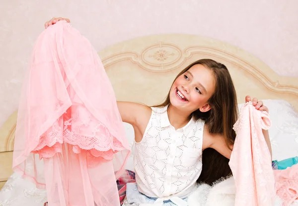 Portrait of smiling happy little girl child schoolgirl choosing — Stock Photo, Image