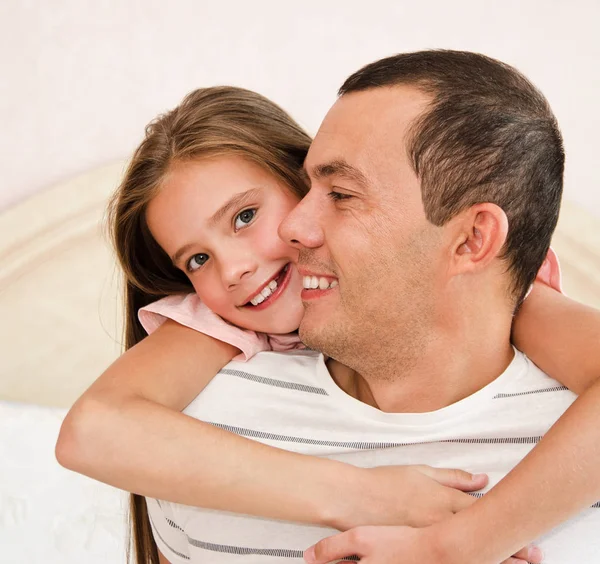 Smiling happy little daughter child  embracing her father sharin — Stock Photo, Image