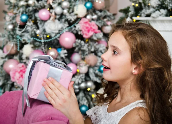 Portrait of adorable happy surprised  little girl child holding