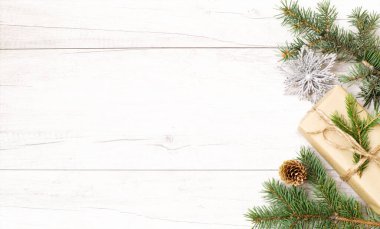 Mutlu Noeller ve duvar kağıtları. Mutlu yıllar kompozisyonu. Noel hediyesi, çam kozalakları, tahta beyaz arka planda köknar dalları. Üst görünüm ve kopyalama alanı