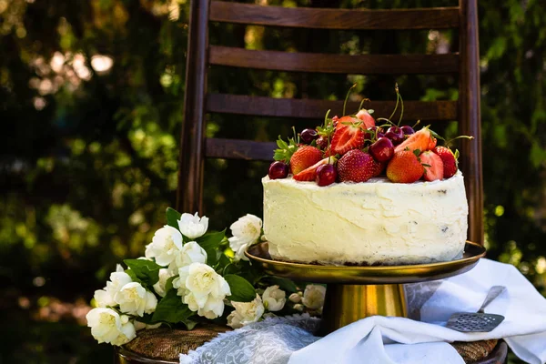 Cake with berries on a summer background. Birthday and summer concept.