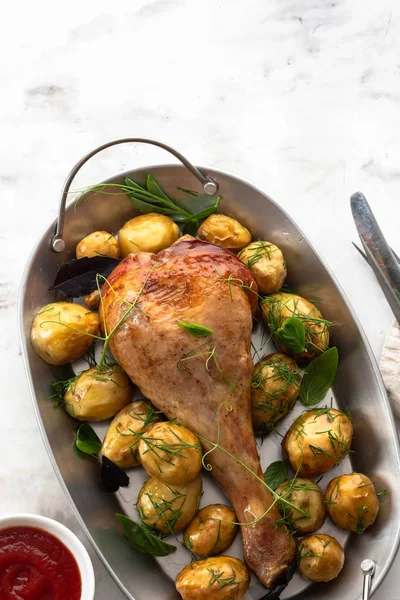 Roast turkey drumsticks with fried potatoes, basil. Holiday dinner. Copy space.