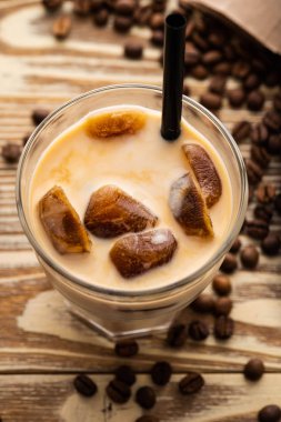 Soğuk kahve cam ahşap masa arka plan üzerinde buz küpleri ile. Buzlu kahve. Kopya alanı.